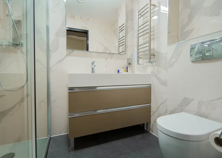 Private bathroom with a mirrored cabinet and towel rail