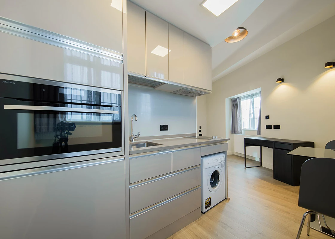 Private fitted kitchen and breakfast bar in a studio
