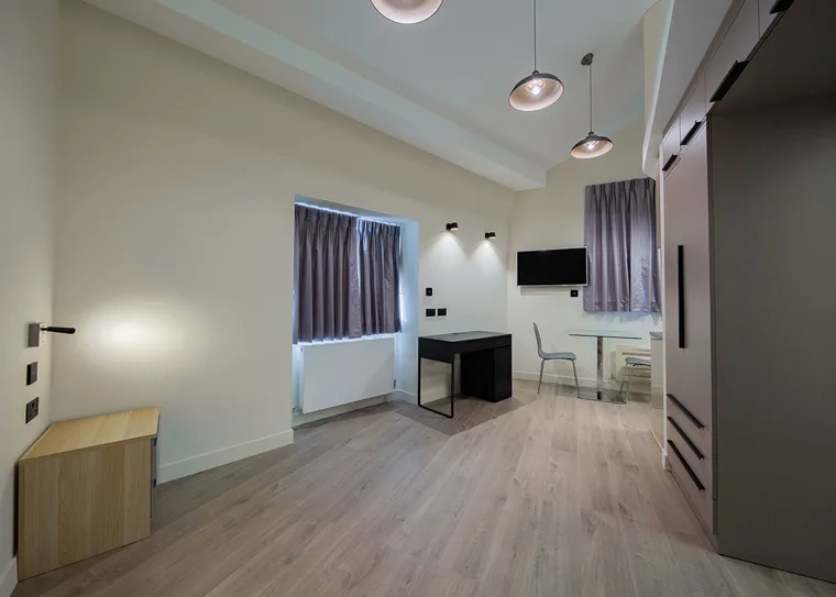 Studio living area with natural light and wooden flooring